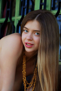 Kay J Poses Sensually In Sunlit Lingerie On The Beach Teasing With Playful Nudity