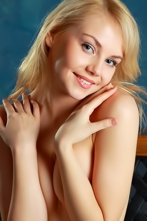 Blonde with blue eyes gives a hot smile