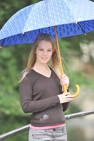 Blonde Girl Next-door Type Holds An Umbrella