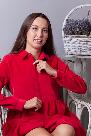 Zarusha Strips Out Of A Red Shirt Dress On A White Wicker Chair