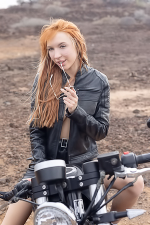 Lilly Mays Rides A Motorcycle In The Desert Wearing A Leather Jacket And Miniskirt