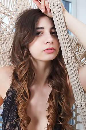 Elle Mira enjoys playful poses in her black lace lingerie